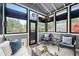 Cozy sunroom featuring comfortable seating, ample light, and backyard views at 4312 Shillham Ct, Cumming, GA 30040