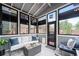 Inviting sunroom with abundant natural light, stylish furniture and lots of windows at 4312 Shillham Ct, Cumming, GA 30040
