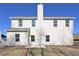 Back exterior of a home with white siding, a chimney, and a concrete patio at 484 Charleston Pl, Villa Rica, GA 30180