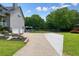 The home features a basketball court, attached garage, beautiful lawn, and flower bed at 117 Village Ct, Woodstock, GA 30188