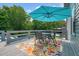 Outdoor dining area with a colorful rug and umbrella, perfect for al fresco meals at 117 Village Ct, Woodstock, GA 30188