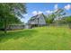 Spacious backyard featuring a deck, pool, fenced area, and ample green space at 117 Village Ct, Woodstock, GA 30188