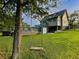 Backyard featuring a swing, lush lawn, and a deck with outdoor seating and a pool at 117 Village Ct, Woodstock, GA 30188