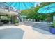 Backyard view of concrete and wooden patio areas with lounge chairs and access to the pool at 117 Village Ct, Woodstock, GA 30188