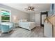 Bright bedroom with a ceiling fan, white bed frame, and a large window with natural light at 117 Village Ct, Woodstock, GA 30188
