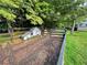 Well-maintained chicken coop and fenced-in run in a spacious backyard at 117 Village Ct, Woodstock, GA 30188