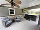 Covered patio with hot tub, seating, ceiling fan, and mounted TV, perfect for outdoor enjoyment at 117 Village Ct, Woodstock, GA 30188