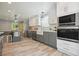 Bright kitchen featuring gray and white cabinets, stainless steel appliances, and a farm sink at 117 Village Ct, Woodstock, GA 30188