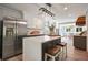 Modern kitchen featuring stainless steel appliances, a center island, and an open layout to dining area at 117 Village Ct, Woodstock, GA 30188