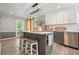 Contemporary kitchen with gray and white cabinets, a center island, and stainless steel appliances at 117 Village Ct, Woodstock, GA 30188