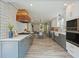A bright, open kitchen with gray cabinets, subway tile backsplash, and a large island at 117 Village Ct, Woodstock, GA 30188
