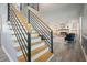 A stairway leading to a living room with a stone fireplace and built-in shelving at 117 Village Ct, Woodstock, GA 30188