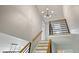 Stylish staircase with modern railing, neutral walls, and views of the first floor at 117 Village Ct, Woodstock, GA 30188