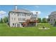 Expansive backyard featuring a deck, patio area, and lush green lawn at 5070 Laurel Ridge Dr, Cumming, GA 30040