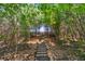 Stone steps ascend through a wooded backyard, creating a tranquil and natural pathway at 5070 Laurel Ridge Dr, Cumming, GA 30040
