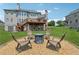 Backyard with seating area surrounding a fire pit for outdoor relaxation at 5070 Laurel Ridge Dr, Cumming, GA 30040