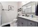 Elegant bathroom featuring gray vanity with granite countertop and decorative mirror at 5070 Laurel Ridge Dr, Cumming, GA 30040