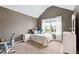 Cozy bedroom featuring neutral carpet, a slanted ceiling, and natural light from a large window at 5070 Laurel Ridge Dr, Cumming, GA 30040