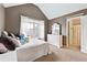 Bright bedroom featuring neutral carpet, natural light from a window, and a doorway to an ensuite bathroom at 5070 Laurel Ridge Dr, Cumming, GA 30040