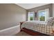 Comfortable bedroom showcasing a gray accent wall, plush carpet, and two large windows with natural light at 5070 Laurel Ridge Dr, Cumming, GA 30040