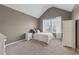 Cozy bedroom with neutral tones, a large window, and vaulted ceiling, providing a relaxing retreat at 5070 Laurel Ridge Dr, Cumming, GA 30040