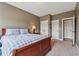Spacious bedroom featuring plush carpeting, a queen bed with a blue and white comforter, and access to closets at 5070 Laurel Ridge Dr, Cumming, GA 30040