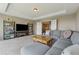 Comfortable bonus room features a gray sectional sofa and stylish shelving at 5070 Laurel Ridge Dr, Cumming, GA 30040