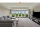 Spacious bonus room with a large window and comfortable seating area at 5070 Laurel Ridge Dr, Cumming, GA 30040