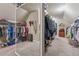 Well-organized walk-in closet with generous shelving, a full-length mirror, and plenty of room for wardrobe storage at 5070 Laurel Ridge Dr, Cumming, GA 30040