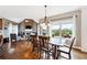 Open-concept dining area with hardwood floors, a view to the living room fireplace, and access to the outdoor deck at 5070 Laurel Ridge Dr, Cumming, GA 30040
