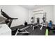 Home gym featuring treadmill, weights, and bench for a complete workout at 5070 Laurel Ridge Dr, Cumming, GA 30040