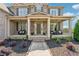 Inviting front porch with comfortable seating, lovely landscaping, and a clear walkway to the front door at 5070 Laurel Ridge Dr, Cumming, GA 30040