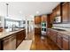 Kitchen features stainless appliances, wooden cabinets, granite countertops, and opens to a living room at 5070 Laurel Ridge Dr, Cumming, GA 30040