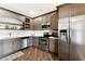 Well-equipped kitchen with gray cabinets, stainless steel appliances, and modern lighting is perfect for cooking and entertaining at 5070 Laurel Ridge Dr, Cumming, GA 30040