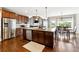 Spacious kitchen featuring stainless appliances, wood cabinets, and a large island with granite countertops at 5070 Laurel Ridge Dr, Cumming, GA 30040
