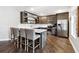 Modern kitchen with a gray island, bar seating, stainless steel appliances, and dark cabinets for ample storage at 5070 Laurel Ridge Dr, Cumming, GA 30040