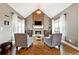 Inviting living room featuring vaulted ceiling, a brick fireplace, hardwood floors, and stylish seating arrangement at 5070 Laurel Ridge Dr, Cumming, GA 30040