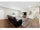 Spacious living room boasts wood floors, a large TV, recessed lighting, a comfy couch and built-in shelving at 5070 Laurel Ridge Dr, Cumming, GA 30040