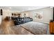 Open-concept living room featuring a comfortable sofa, plush rug, wood floors, and seamless flow to the dining area at 5070 Laurel Ridge Dr, Cumming, GA 30040
