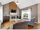 Bright living room with a brick fireplace, hardwood floors, and large windows at 5070 Laurel Ridge Dr, Cumming, GA 30040
