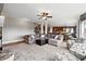 Open-concept living room with a fireplace, staircase, and view of the kitchen and dining area at 5070 Laurel Ridge Dr, Cumming, GA 30040