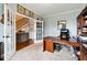 Inviting home office with a dark wooden desk, chair, and ample natural light at 5070 Laurel Ridge Dr, Cumming, GA 30040