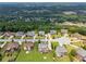 Aerial view captures the layout of a serene cul-de-sac neighborhood surrounded by lush, green trees at 5070 Laurel Ridge Dr, Cumming, GA 30040