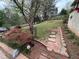 Landscaped backyard with blooming azaleas, a stone walkway, and lush greenery at 945 Blackwell Rd, Marietta, GA 30066
