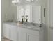 Elegant bathroom with white cabinets, granite countertop, double sinks, and modern lighting at 507 Regency Trl, Acworth, GA 30102