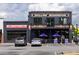 Mellow Mushroom restaurant with a second story balcony and outdoor seating with blue umbrellas at 507 Regency Trl, Acworth, GA 30102