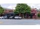 Downtown storefronts featuring a restaurant and a record shop with parked cars out front at 507 Regency Trl, Acworth, GA 30102