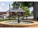 Historic red brick train depot behind a water fountain on a well manicured lawn and foliage at 507 Regency Trl, Acworth, GA 30102