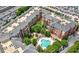 Aerial view of condo complex with a clover-shaped pool, green spaces, and parking at 1735 Peachtree Ne St # 316, Atlanta, GA 30309
