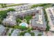Aerial view of a red brick condo complex featuring a pool, parking, and mature trees at 1735 Peachtree Ne St # 316, Atlanta, GA 30309